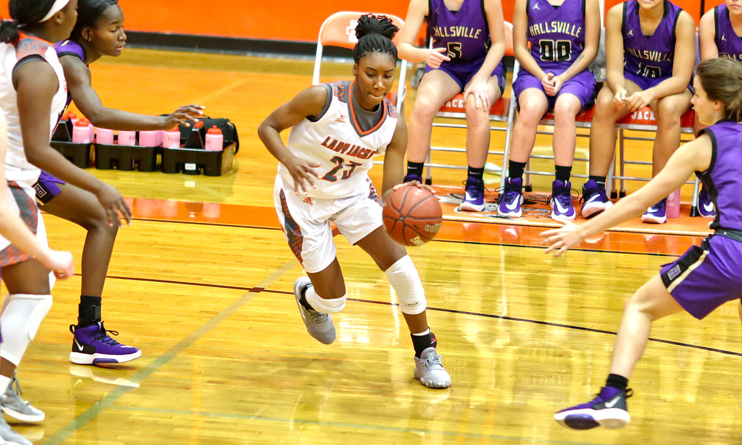 Lady Jacket Tahjae Black drives into the lane in action against Hallsville.